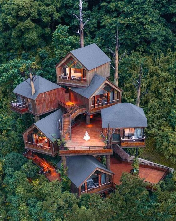 The complex tree house with multiple floors in the woods
